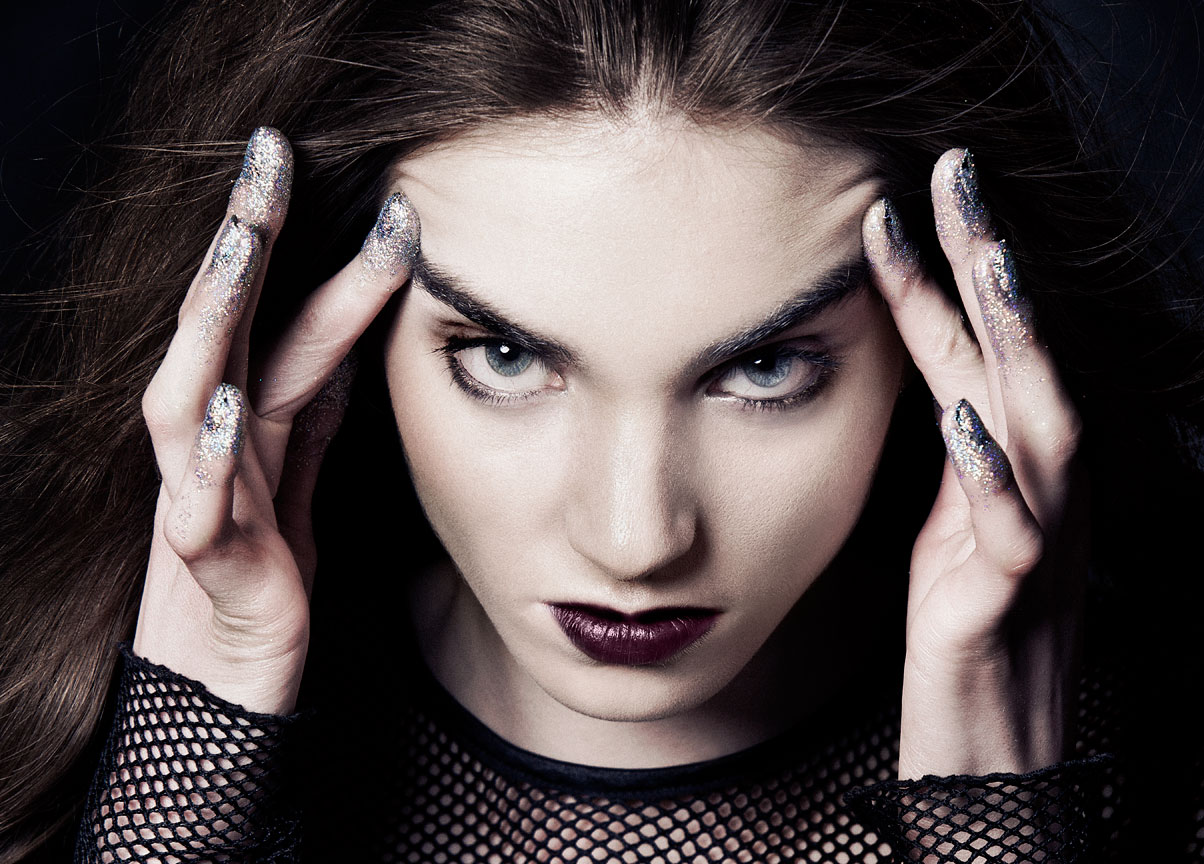 Girl with glitter on her fingers and a dark purple lip wearing mesh