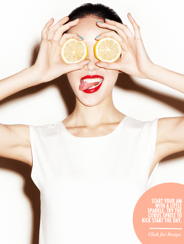 Girl holding lemons up to her eyes