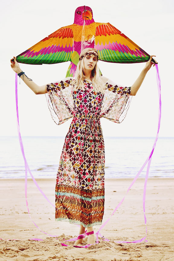 boho girl on beach with kite