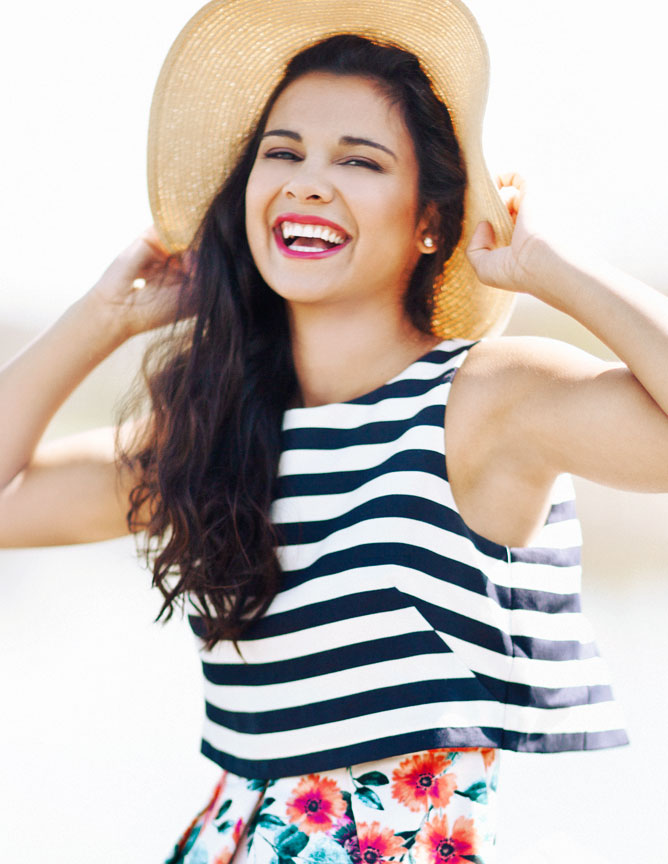 Girl holding hat laughing